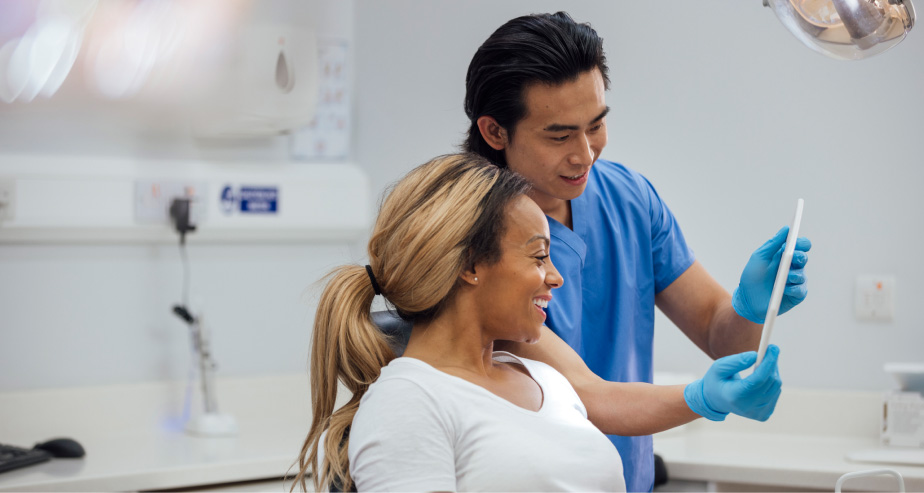 A woman receives a teeth cleaning from her dentist